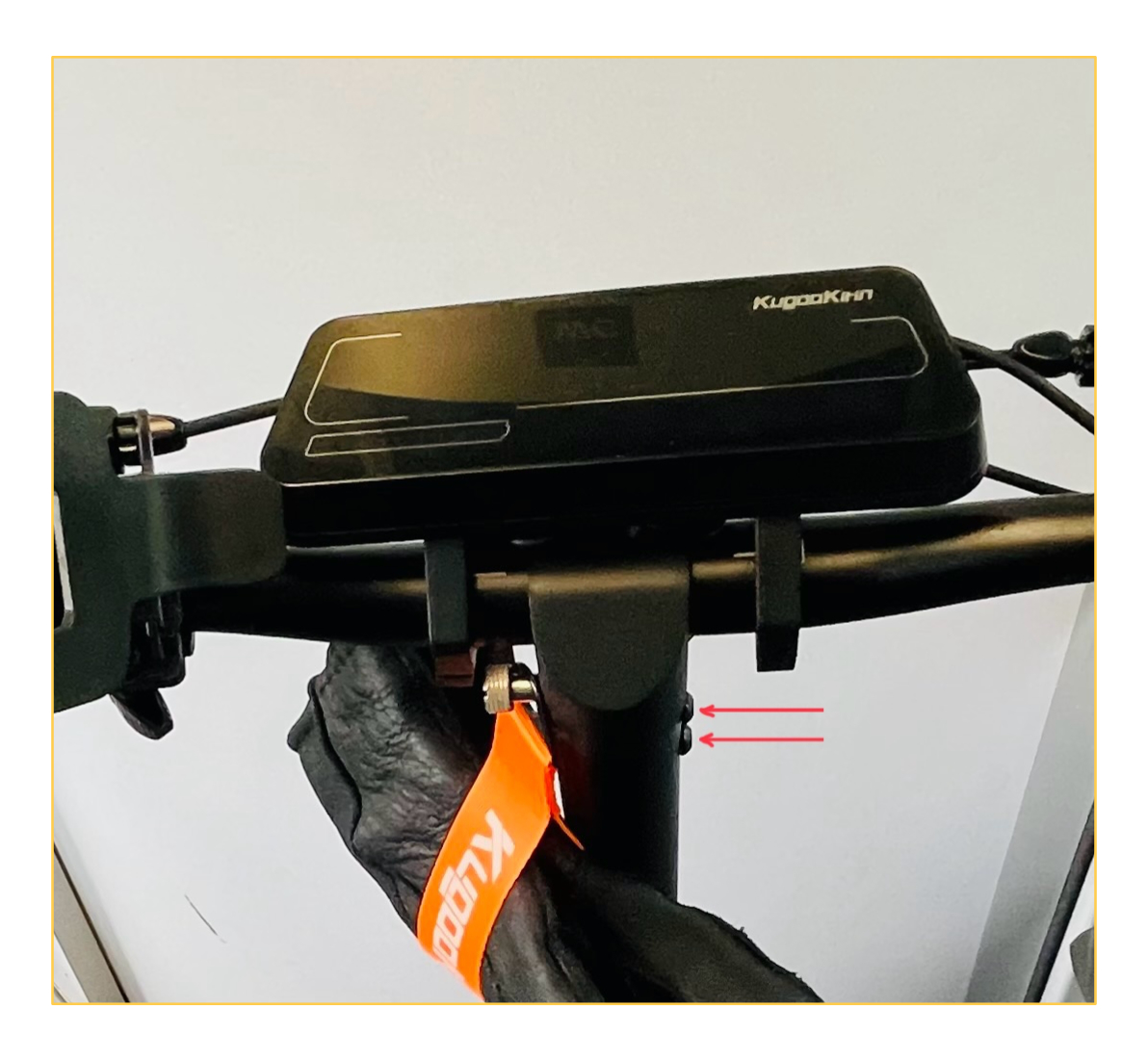The hex socket screws holding the scooter handlebar, marked with arrows
